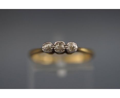 A stamped 18ct/plat three stone ring set with three old brilliant cut diamonds measuring from 2.50mm to 3.00mm.  NB: Measurem