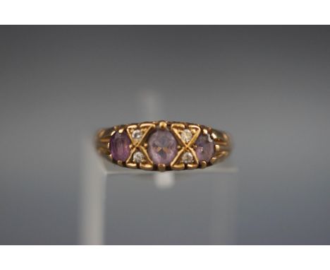 A 9 carat gold dress ring set with amethyst and diamonds. Hallmarked 9ct gold, London, 1991 'ATLd' 2.1 grams