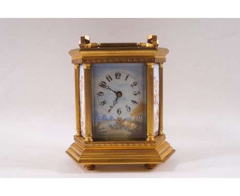 A 20th century French brass carriage clock, the six sided case with column supports and inset porcelain panels painted with c