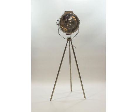 A large industrial metal lamp on tripod base with adjustable swivel head, 160cm high