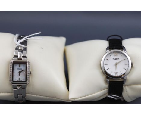 A collection of two boxed Pulsar wristwatches: a lady's stainless steel watch with leather strap and pin buckle, round white 