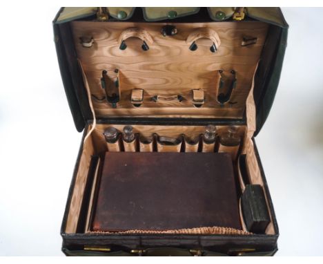 A green leather ladies dressing case with gilt initials 'V.H.', the retailers stamp 'Goldsmiths and Silversmiths, 42 Regent S