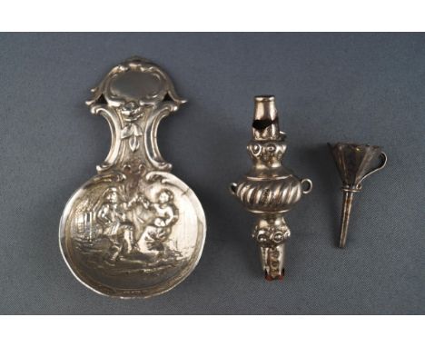 A silver caddy spoon embossed with tavern figures in the Dutch Style, London import marks 1968, together with a silver hip fl