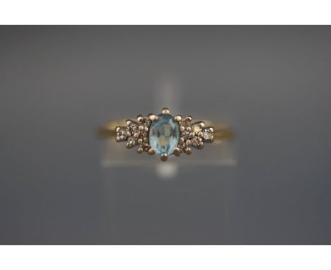 A hallmarked 18 carat gold dress ring set with aquamarine and diamonds. Gross weight; 2.7 grams