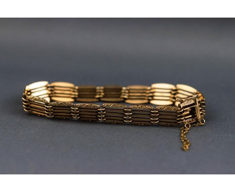 A hallmarked 9ct gold five bar bracelet having a filigree scroll engraved design to the outer links. Push in clasp with figur