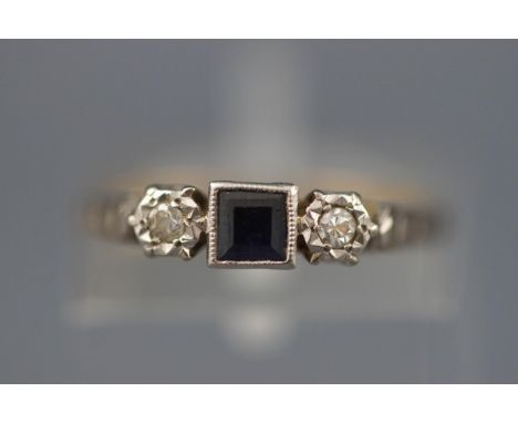 An early 20th century gold, sapphire and diamond three stone ring, centred with a small square step-cut sapphire, rub-over se