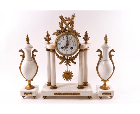 A French white marble and ormolu clock garniture, the eight day clock with painted enamel dial, surmounted by oak leaves, tor