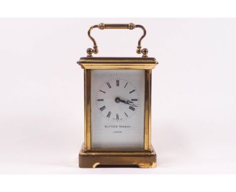 A 20th century brass carriage clock with Swiss movement, retailed by Matthew Norman, London, with winding key, 15cm high incl