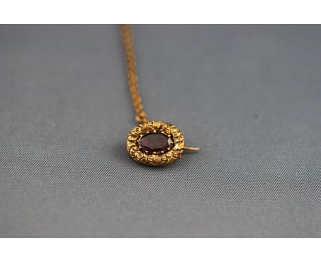 A small George III yellow metal brooch set with an oval faceted rhodolite garnet measuring approximately 7.00mm x 4.60mm. Pin