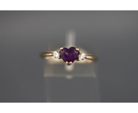 An 18 carat white gold amethyst and diamond three stone ring. Hallmarked 18ct, London, 2007. 3.0 grams. boxed