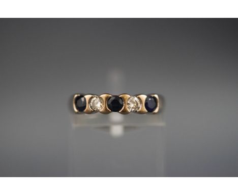 A hallmarked 18ct white gold half hoop ring set with three round sapphires and two diamonds measuring approximately 3.00mm di