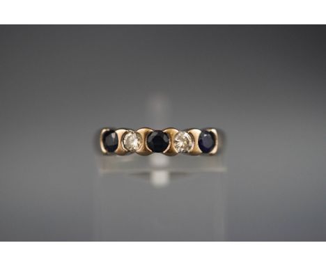 A hallmarked 18ct white gold half hoop ring set with three round sapphires and two diamonds measuring approximately 3.00mm di