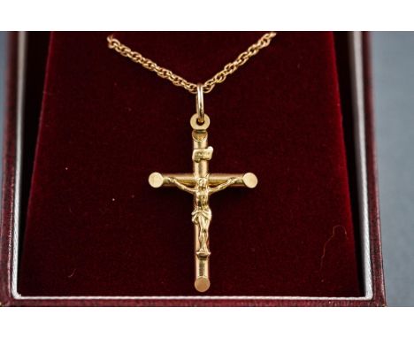 A boxed hallmarked 9 carat gold crucifix pendant, suspended from a twisted rope chain, bolt ring clasp, 380mm (hallmarked 9ct