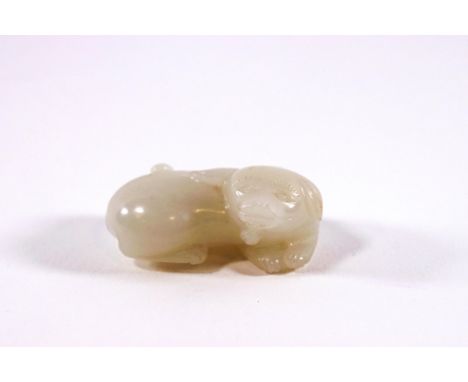 A Chinese white jade carving of a recumbent dog, 4.5cm wide