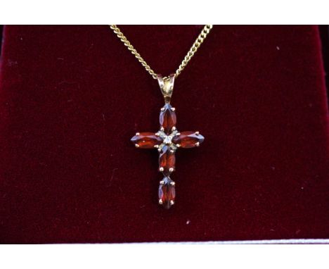 A hallmarked 9ct gold cross pendant set with five marquise cut garnet (5.8mm x 3.00mm approximately) central set with a singl