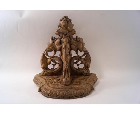 A 19th century Continental carved wood wall bracket, the shaped shelf supported by a  mythical beast, pierced and carved scro