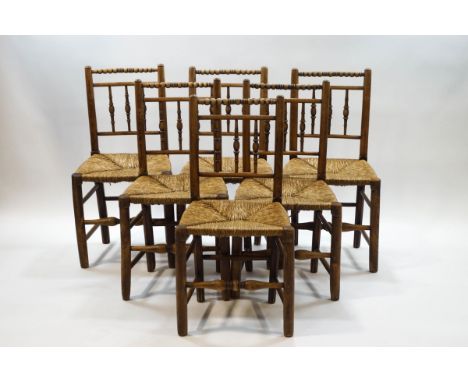 A set of six turned ash dining chairs with bobbin turned crest rails, spindle backs and rush seats