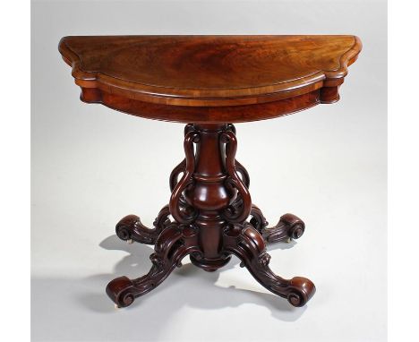 Fine Victorian mahogany card table, the demilune shaped top opening to a baize playing surface above a timed column with arch