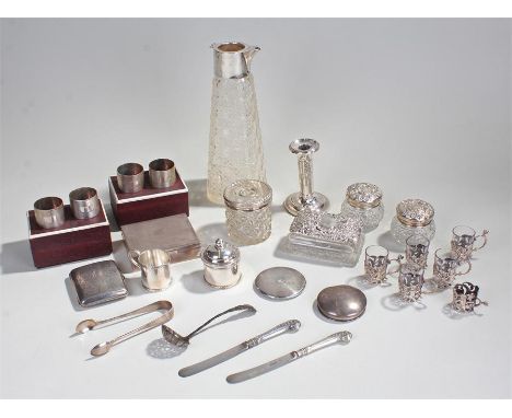 Mixed silver wares to include a candlestick, napkin rings, cigarette case, coffee cups, canisters, etc (qty)