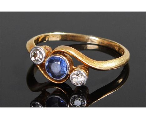 18 carat gold diamond and sapphire ring, the central sapphire flanked by two diamonds, ring size M