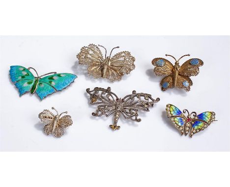 Collection of six butterfly brooches, to include: three filigree examples, an enamel and seedpearl one, a large enamelled sil