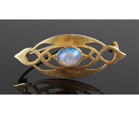 Arts and Crafts style gold and opal brooch. The pierced decoration in the manner of Archibald Knox and set with a central opa