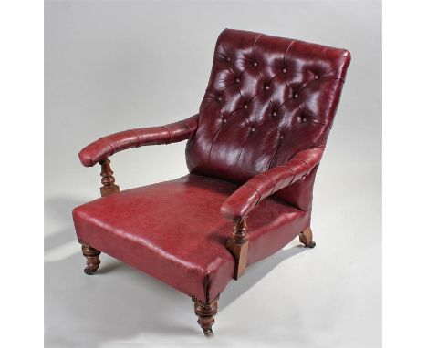 Victorian leather armchair, the leather button back above a stuff over seat and shaped arms raised on turned legs, 88cm deep,