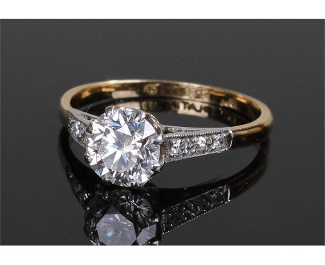 18 carat gold diamond solitaire ring. The diamond at approximately 1.1 carats, flanked by a further six diamonds to the shoul