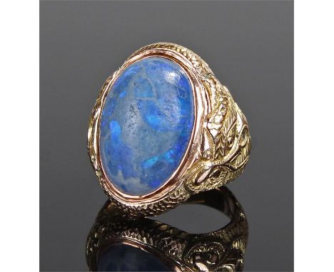 Yellow metal blue opal ring, the domed opal set within a twisted dragon shank, ring size L