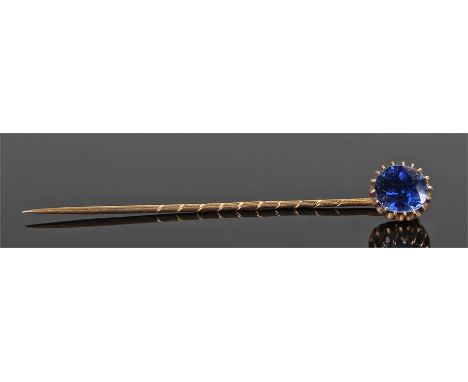 Sapphire and yellow metal stick pin, the sapphire held with claws on a pin shaft, the sapphire possibly Ceylon origin 