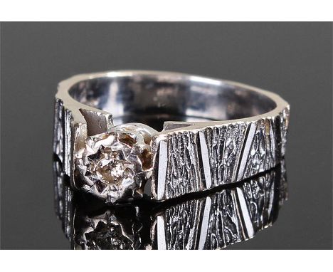 18 carat white gold diamond set ring, the central diamond with bark effect shoulders and shank, ring size K