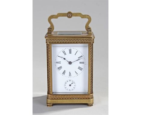 French gilt brass carriage alarm clock. The arched carrying handle above a glass top front back and sides, leaf decoration to