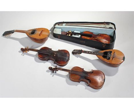 Neopolitan twelve string bowl backed mandolin, together with an eight stringed example and three violins (a/f)