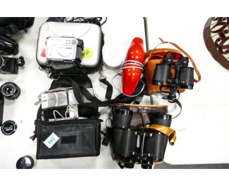 A mixed collection of items to include Hitachi DVD Cam, Minolta g600 digital camera. Regent branded Binoculars &amp; novelty 