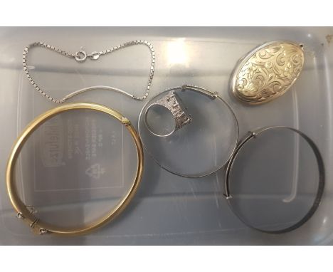 A collection of silver items to include a silver gilt locket pendant, 2 silver bangles, a silver bracelet and a 1941 threepen