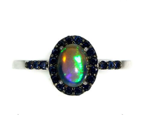 A 925 silver cluster ring set with a cabochon cut opal and sapphires, (P).