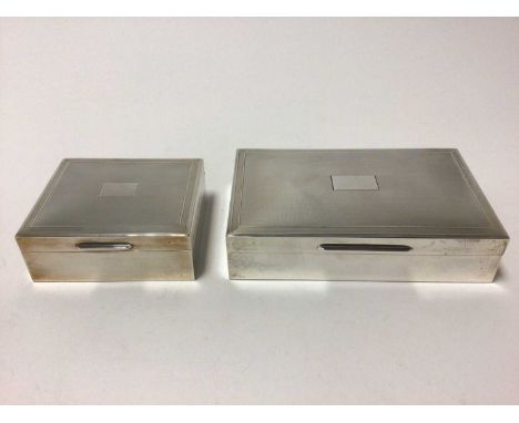 Two silver cigarette boxes with engine turned decoration and blank cartouches, 14.5cm x 9cm and 9cm x 8cm, London 1963 and 19