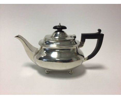 George V sterling silver teapot, with ebony handle and knop, raised on ball feet, 24cm from spout to handle, Sheffield 1928 (