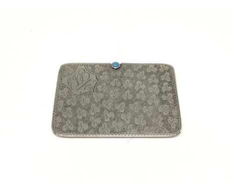 A rectangular silver double postage stamp case, with sliding action, cabochon turquoise thumb piece, and engine turned foliat