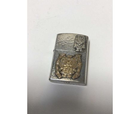 Peruvian hammered silver lighter with applied Inca motifs, stamped 'Peru 925 18k'