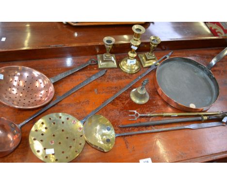 A 19th century copper ladle; a similar copper cream skimmer; a brass ladle; a heavy gauge copper pan, cast iron handle; a pai