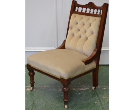 A Victorian mahogany nursing chair, shaped and spindled top rail, button upholstered back, stuffed overseat, turned forelegs,