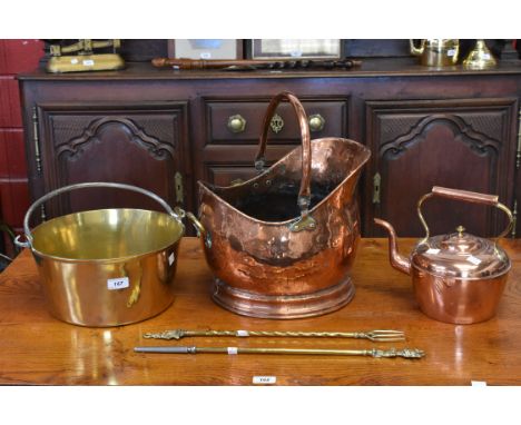Metalware - a large brass jam pan; a copper helmet shaped coal scuttle; a copper kettle; a poker and a toasting fork (5)