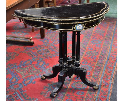 A 19th century porcelain and gilt metal mounted shaped demi-lune card table, folding top enclosing an inset baize playing sur