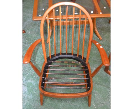 An Ercol spindle back open arm chair.