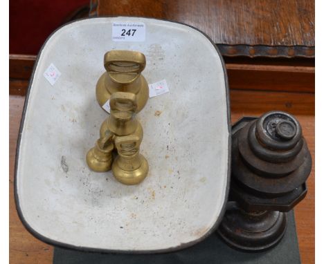 A cast iron set of counter balance weighing scales with weights.