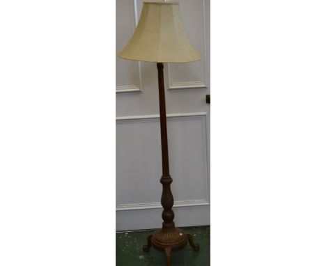 A walnut standard lamp, lion paw feet