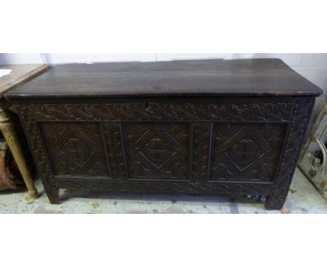 COFFER, James II oak with a rising lid, later sandalwood lining and carved triple panel front, 61cm x 150cm x 76cm H. (with f