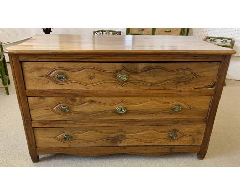 COMMODE, mid 18th century French Louis XV period walnut, having three carved drawers with a shaped top and apron, 76cm h x 12
