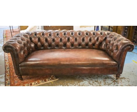 CHESTERFIELD SOFA, Victorian mahogany re upholstered in buttoned brown leather with turned feet and castors, 211cm W.